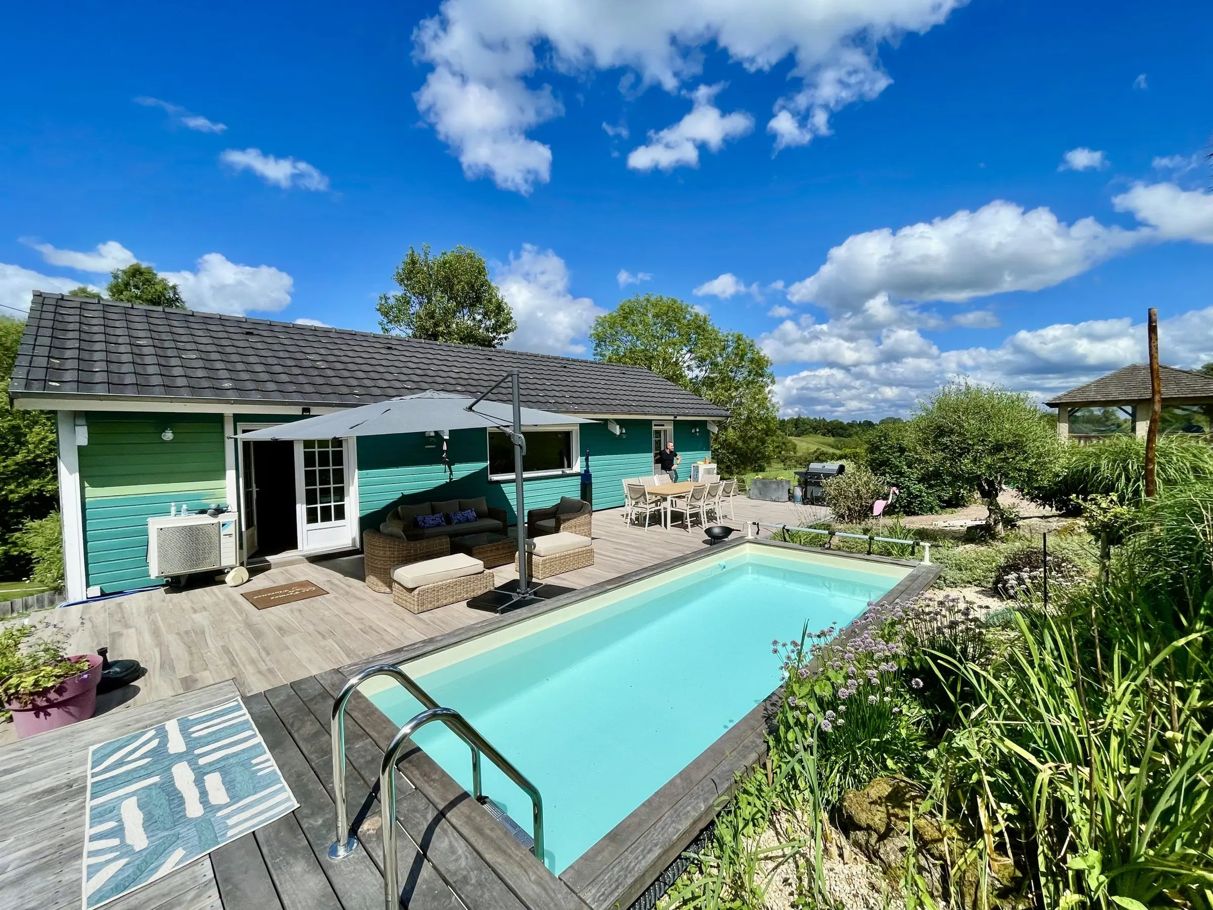 La piscine chauffée longe la terrasse de bois du Chalet Normand