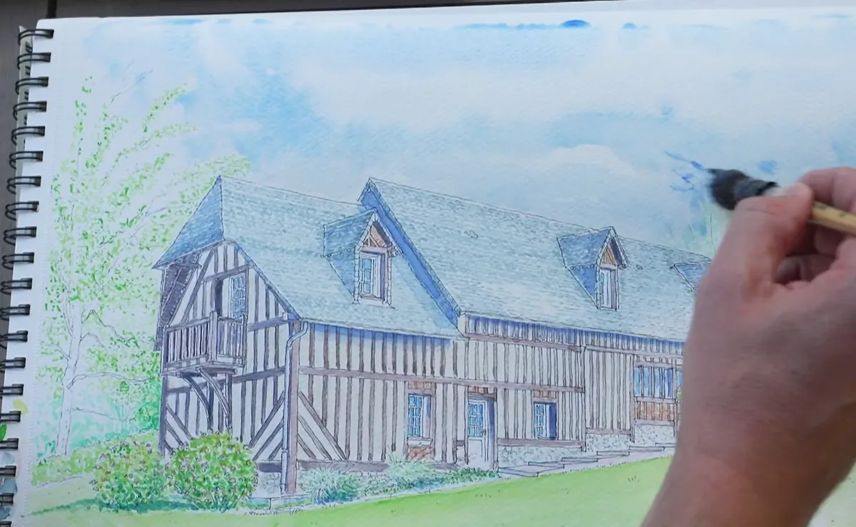 L’aquarelle presque finie : Reinette Grise sous un ciel bleu, le pinceau de Cyp encore dans les nuages
